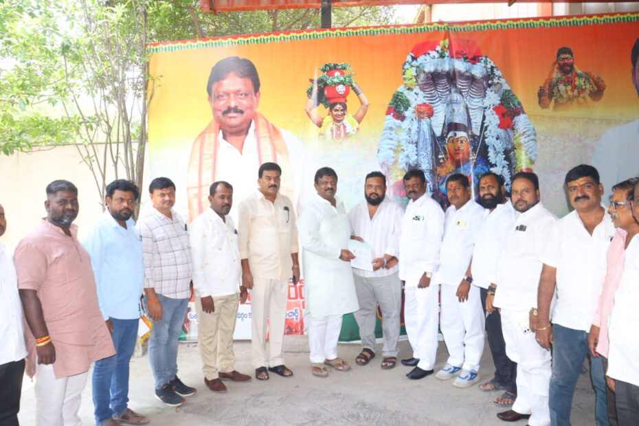 Kolan Hanmanth Reddy distributing CMRF checks to beneficiaries in Quthbullapur.