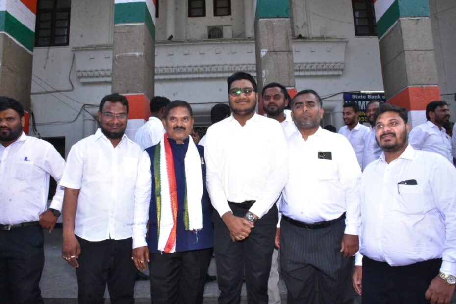 Telangana Advocates Protection Bill passed in assembly, TPCC Legal Cell felicitates Chairman Ponnam Ashok Goud in Gandhi Bhavan with a pink shawl, background shows Congress flags.